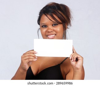 Young Hispanic Woman Holding A Blank Note Card.