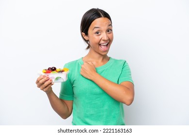 Young Hispanic Woman Holding A Bowl Of Fruit Isolated On White Background Celebrating A Victory