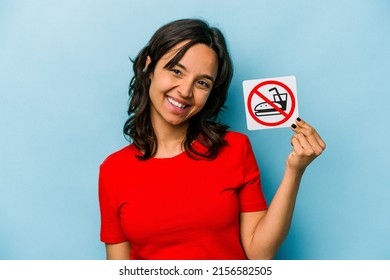 Young Hispanic Woman Holding No Eating Sign Isolated On Blue Background Laughing And Having Fun.