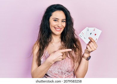 Young Hispanic Woman Holding Poker Cards Smiling Happy Pointing With Hand And Finger 