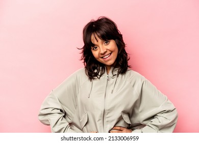 Young Hispanic Woman Isolated On Pink Background Confident Keeping Hands On Hips.