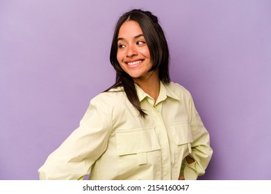 Young Hispanic Woman Isolated On Purple Background Confident Keeping Hands On Hips.