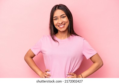 Young Hispanic Woman Isolated On Pink Background Confident Keeping Hands On Hips.