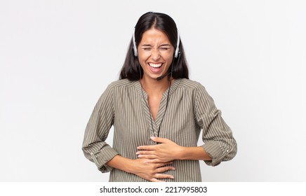 Young Hispanic Woman Laughing Out Loud At Some Hilarious Joke With A Headset. Telemarketing Concept