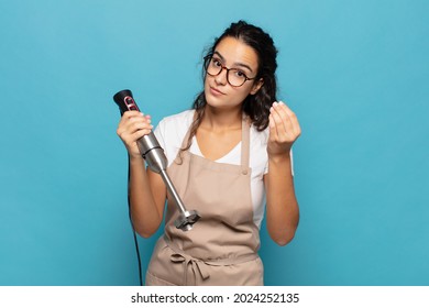 Young Hispanic Woman Making Capice Or Money Gesture, Telling You To Pay Your Debts!