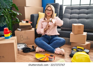 Young Hispanic Woman Moving To A New Home Sitting On The Floor Doing Time Out Gesture With Hands, Frustrated And Serious Face 