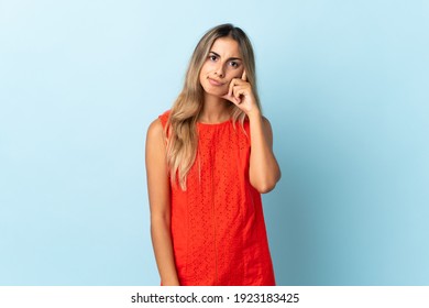 Young Hispanic Woman Over Isolated Blue Background Thinking An Idea