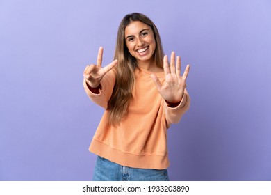 Young hispanic woman over isolated purple background counting seven with fingers