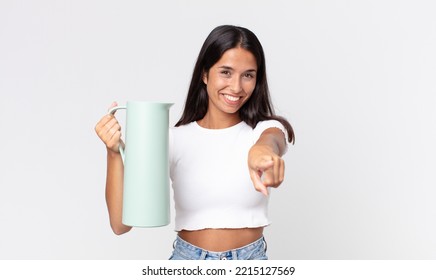 Young Hispanic Woman Pointing At Camera Choosing You And Holding A Coffee Thermos