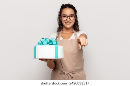 young hispanic woman pointing at camera with a satisfied, confident, friendly smile, choosing you - Powered by Shutterstock