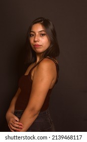 Young Hispanic Woman Portrait, Straight Hair. Black Background.