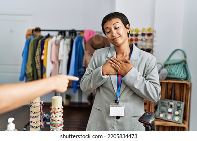 Young Hispanic Woman Shopkeeper Smiling Confident Working At Clothing Store