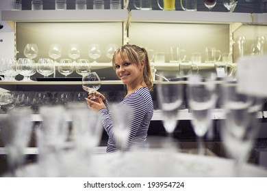 Young Hispanic Woman Shopping For Furniture, Glasses, Dishes And Home Decor In Store