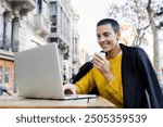 young hispanic woman in short hair using laptop or computer in urban city coffee terrace or coffee shop, Portrait of Latin female in street outdoors in autumn season