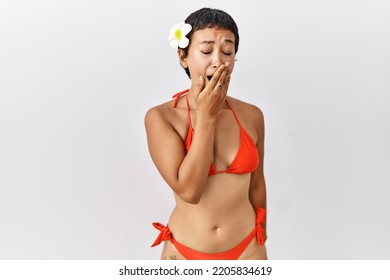 Young Hispanic Woman With Short Hair Wearing Bikini Bored Yawning Tired Covering Mouth With Hand. Restless And Sleepiness. 