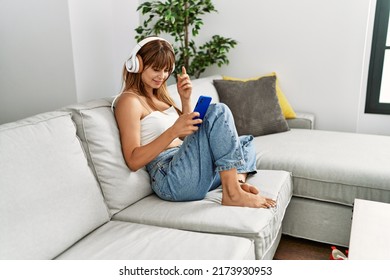 Young hispanic woman smiling confident listening to music at home - Shutterstock ID 2173930953