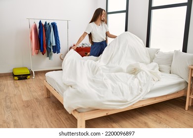 Young Hispanic Woman Smiling Confident Make Bed At Bedroom