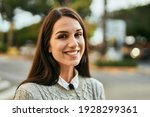 Young hispanic woman smiling happy standing at the city.