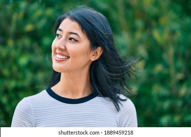 Young Hispanic Woman Smiling Happy Walking At The Park.