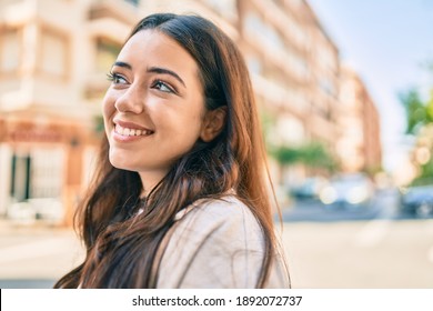 Young Hispanic Woman Smiling Happy Walking At The City.