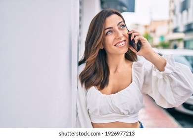 Young hispanic woman smiling happy talking on the smartphone at the city. - Shutterstock ID 1926977213