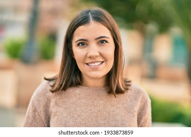 Young Hispanic Woman Smiling Happy Standing At The City.