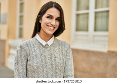 Young hispanic woman smiling happy standing at the city. - Shutterstock ID 1937263813