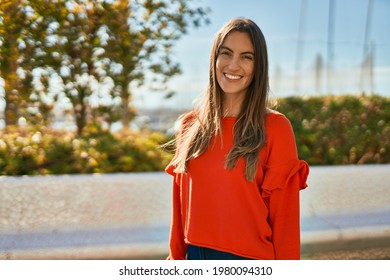 Young Hispanic Woman Smiling Happy Standing At The City.