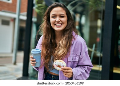 Young hispanic woman smiling happy having breakfast at the city. - Powered by Shutterstock