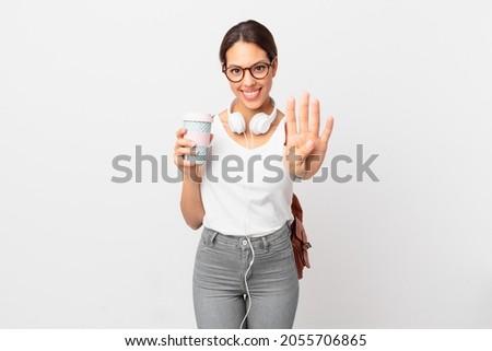 young hispanic woman smiling and looking friendly, showing number four. student concept