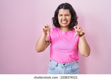 Young Hispanic Woman Standing Over Pink Background Smiling Funny Doing Claw Gesture As Cat, Aggressive And Sexy Expression 