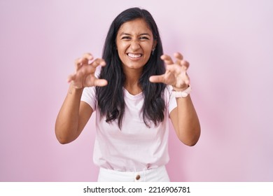 Young Hispanic Woman Standing Over Pink Background Smiling Funny Doing Claw Gesture As Cat, Aggressive And Sexy Expression 