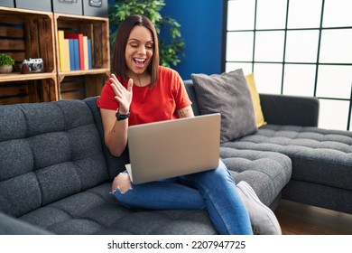 Young Hispanic Woman Using Laptop At Home Celebrating Victory With Happy Smile And Winner Expression With Raised Hands 