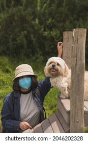 A Young Hispanic Woman Walking With Her Pet Dog Through Nature