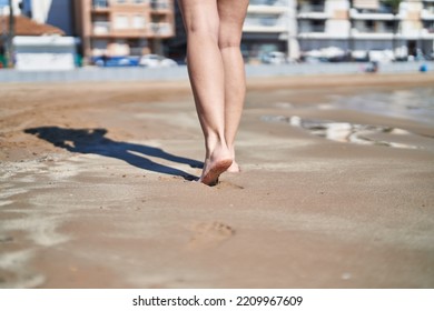 Young Hispanic Woman Walking On Sand At Seaside