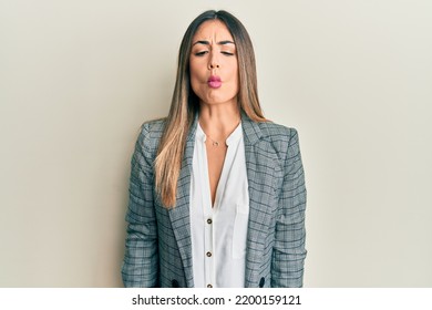 Young Hispanic Woman Wearing Business Clothes Making Fish Face With Lips, Crazy And Comical Gesture. Funny Expression. 