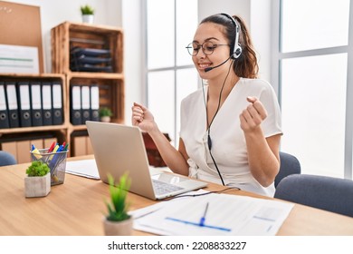 Young Hispanic Woman Wearing Call Center Agent Headset At The Office Screaming Proud, Celebrating Victory And Success Very Excited With Raised Arms 