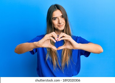 Young Hispanic Woman Wearing Casual Clothes Smiling In Love Doing Heart Symbol Shape With Hands. Romantic Concept. 