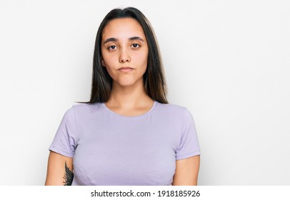 Young Hispanic Woman Wearing Casual Clothes With Serious Expression On Face. Simple And Natural Looking At The Camera. 