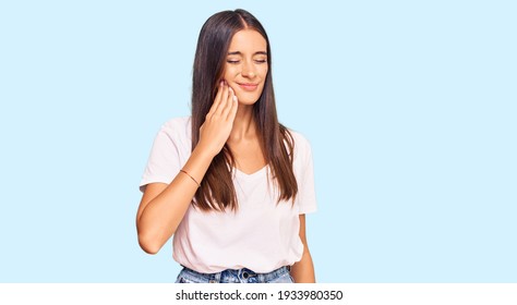 Young Hispanic Woman Wearing Casual White Tshirt Touching Mouth With Hand With Painful Expression Because Of Toothache Or Dental Illness On Teeth. Dentist 