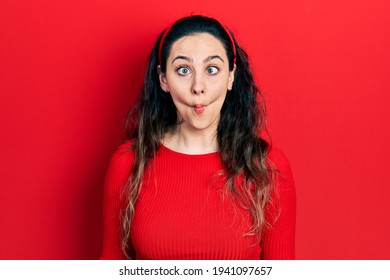 Young Hispanic Woman Wearing Casual Clothes Making Fish Face With Lips, Crazy And Comical Gesture. Funny Expression. 