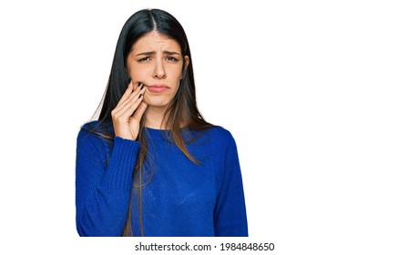 Young Hispanic Woman Wearing Casual Clothes Touching Mouth With Hand With Painful Expression Because Of Toothache Or Dental Illness On Teeth. Dentist 