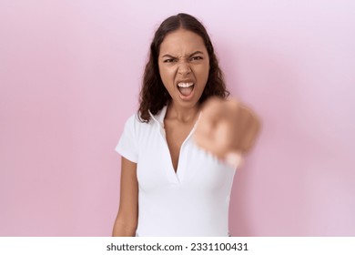 Young hispanic woman wearing casual white t shirt pointing displeased and frustrated to the camera, angry and furious with you  - Shutterstock ID 2331100431