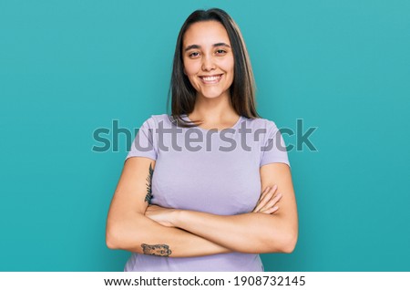 Young hispanic woman wearing casual clothes happy face smiling with crossed arms looking at the camera. positive person. 