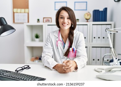 Young Hispanic Woman Wearing Doctor Uniform Working At Clinic