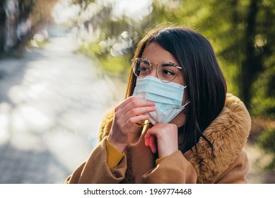 Young Hispanic Woman Wearing Protective Mask While Outside