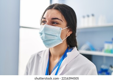 Young Hispanic Woman Wearing Scientist Uniform And Medical Mask At Laboratory