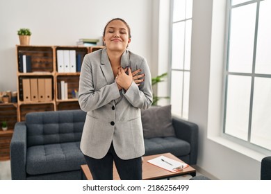 Young Hispanic Woman Working At Consultation Office Smiling With Hands On Chest, Eyes Closed With Grateful Gesture On Face. Health Concept. 