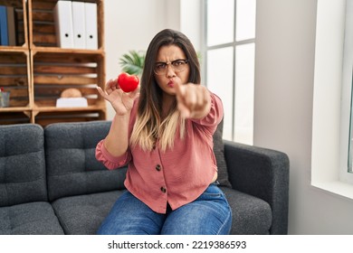 Young Hispanic Woman Working On Couple Therapy At Consultation Office Pointing With Finger To The Camera And To You, Confident Gesture Looking Serious 