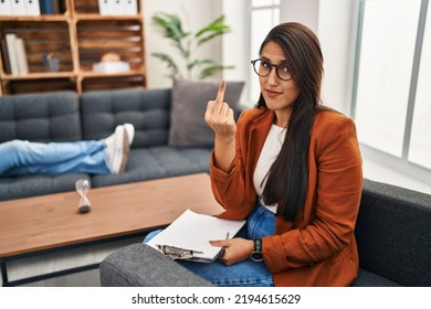 Young Hispanic Woman Working As Psychology Counselor Showing Middle Finger, Impolite And Rude Expression 